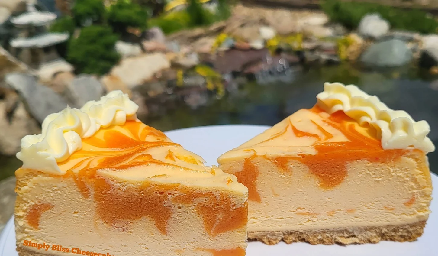 Orange Creamsicle cheesecake slices topped with cream